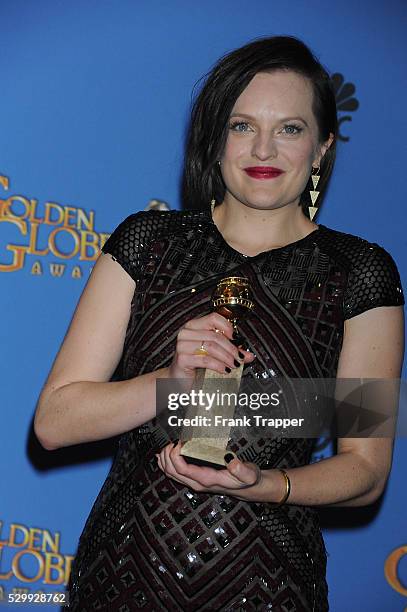 Actress Elisabeth Moss, winner of Best Performance in a Miniseries or Television Film for "Top of the Lake", posing at the 71st Annual Golden Globe...