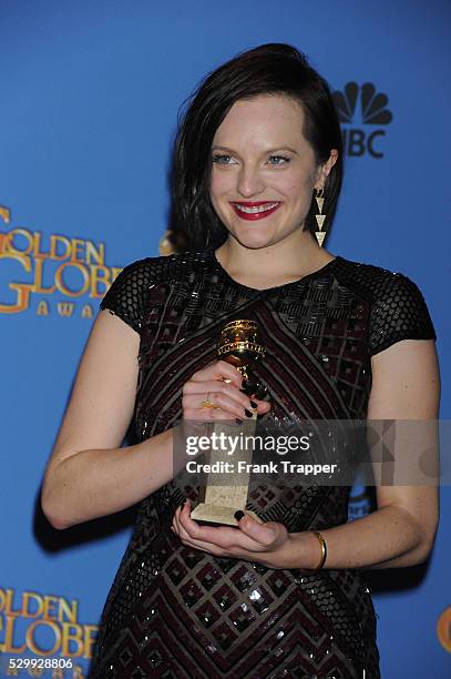 Actress Elisabeth Moss, winner of Best Performance in a Miniseries or Television Film for "Top of the Lake", posing at the 71st Annual Golden Globe...