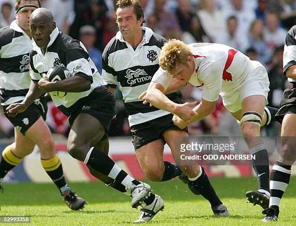 Wendell Sailor of the Barbarians breaks a tackle from Hugh Vyvyan of England during a rugby union match at Twickenham in west London 28 May 2005. AFP...