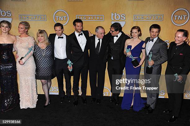 Members of the cast of "American Hustle," winners of the Best Cast in a Motion Picture award, pose at the 20th Annual Screen Actors Guild Awards held...