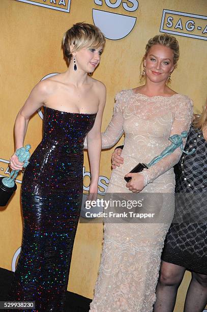 Actresses Jennifer Lawrence and Elisabeth Rohm, members of the cast of '"American Hustle", winner of the Best Cast in a Motion Picture award, pose at...