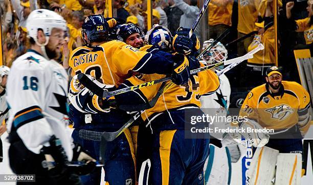 Nick Spaling of the San Jose Sharks skates by as Paul Gaustad and Pekka Rinne of the Nashville Predators celebrate with Roman Josi after a 4-3...