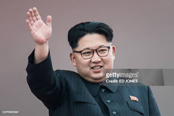 North Korean leader Kim Jong-Un waves from a balcony of the Grand People's Study House following a mass parade marking the end of the 7th Workers...