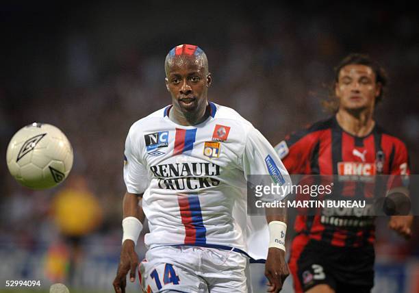 Lyon's French forward Sidney Govou fights for the ball with Nice's defender Jose Cobos , 28 May 2005 at Gerland Stadium in Lyon, during their French...