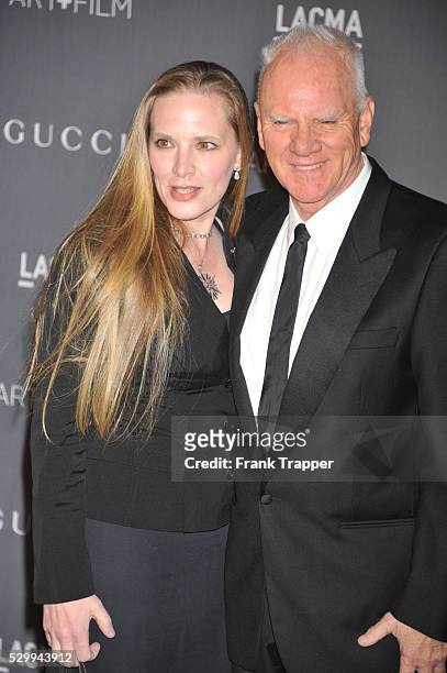 Actor Mlcolm McDowell and guest Kelley Kuhr arrive at LACMA 2012 Art + Film Gala held at LACMA.
