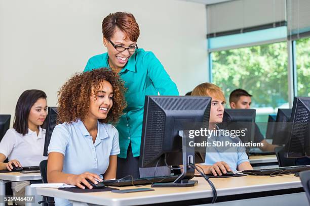 professor in private high school computer lab teaching diverse students - african american school uniform stock pictures, royalty-free photos & images