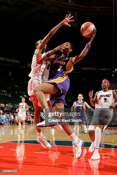 Chamique Holdsclaw of the Los Angeles Sparks shoots over Tynesha Lewis of the Charlotte Sting on May 28, 2005 at the Charlotte Coliseum in Charlotte,...