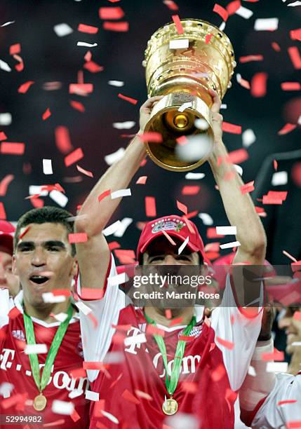 Roy Makaay of Bayern presents the trophy after winning the German Football Federations Cup Final between FC Schalke 04 and Bayern Munich on May 28,...