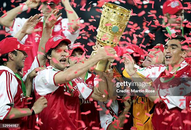 Claudio Pizarro, Michael Ballack, Oliver Kahn and Lucio of Bayern presents the trophy after winning the German Football Federations Cup Final between...