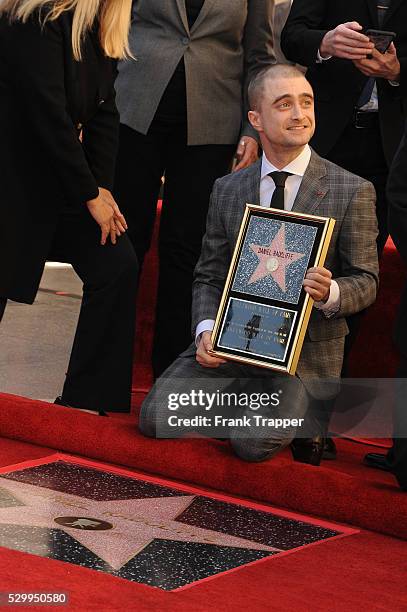 Actor Daniel Radcliffe posing at the ceremony that honored him with a Star on the Hollywood Walk of Fame.