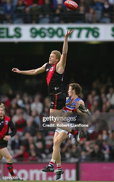 Dustin Fletcher of the Bombers is challenged by Robert Murphy of the Bulldogs during the round 10 AFL match between the Essendon Bombers and the...