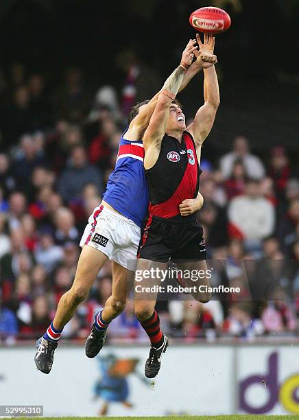 Matthew Lloyd of the Bombers is challenged by Brian Harris of the Bulldogs during the round 10 AFL match between the Essendon Bombers and the Western...