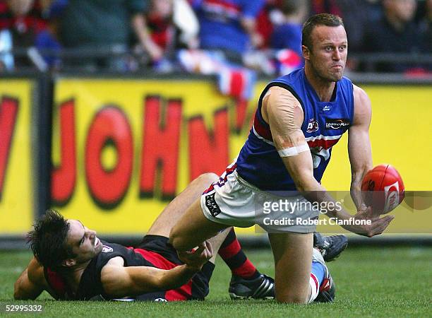 Chris Grant of the Bulldogs looks to get away his handball during the round 10 AFL match between the Essendon Bombers and the Western Bulldogs at the...