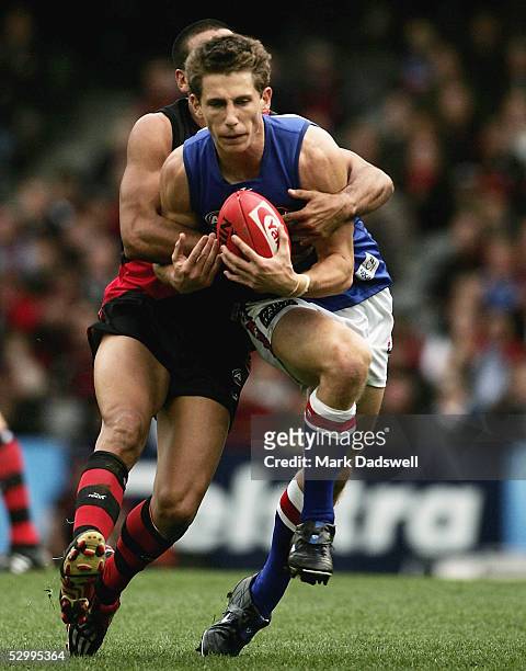 Dale Morris for the Bulldogs is tackled during the AFL Round 10 match between the Essendon Bombers and the Western Bulldogs at Telstra Dome May 29,...