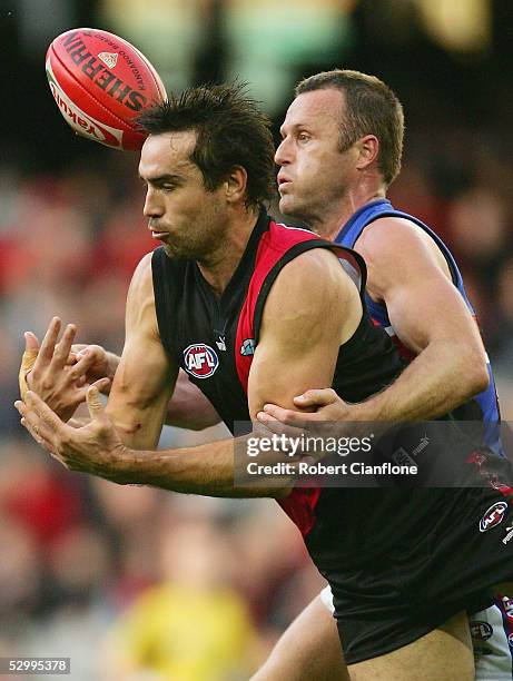 Scott Lucas of the Bombers is challenged by Chris Grant of the Bulldogs during the round 10 AFL match between the Essendon Bombers and the Western...