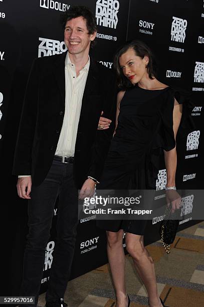 Actress Milla Jovovich and husband, producer Paul W.S. Anderson arrive at the premiere of Zero Dark Thirty held at the Dolby Theater in Hollywood.