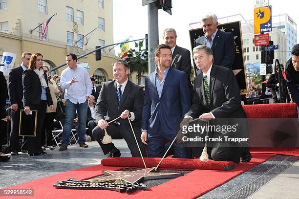 Actor Hugh Jackman and guests pose at the ceremony that honored him with a Star on the Hollywood Walk of Fame, held in front of Madame Tussauds...