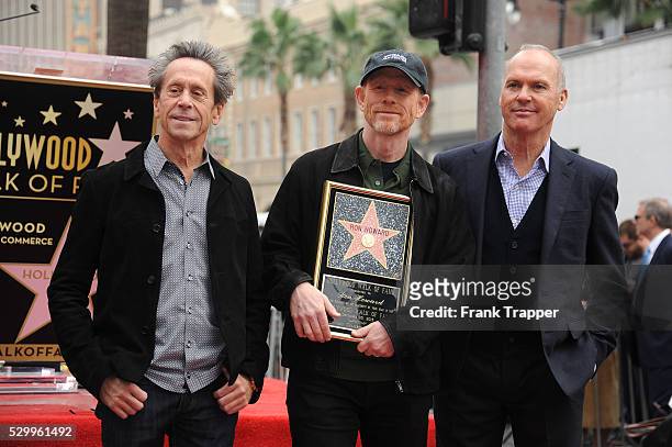 Producer Brian Grazer, director Ron Howard and actor Michael Keaton pose at the ceremony that honored Ron Howard with a Star on the Hollywood Walk of...