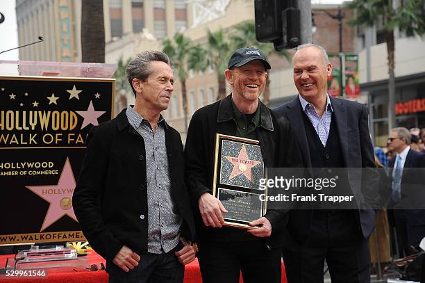 Producer Brian Grazer, director Ron Howard and actor Michael Keaton pose at the ceremony that honored Ron Howard with a Star on the Hollywood Walk of...