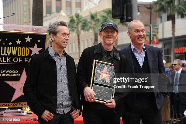 Producer Brian Grazer, director Ron Howard and actor Michael Keaton pose at the ceremony that honored Ron Howard with a Star on the Hollywood Walk of...