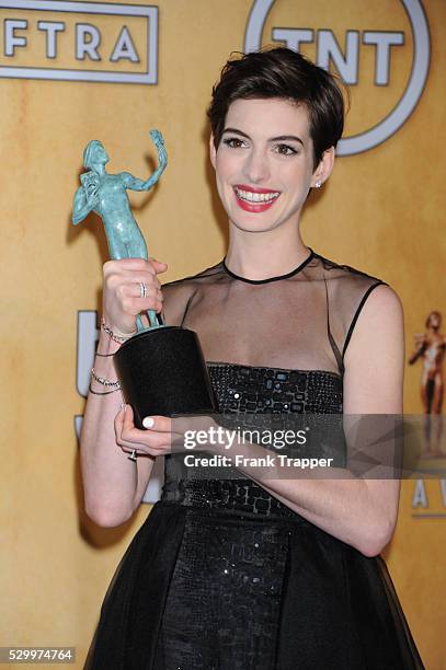 Actress Anne Hathaway, winner of Outstanding Performance by a Female Actor in a Supporting Role for Les Miserables, poseing at the 19th Annual Screen...