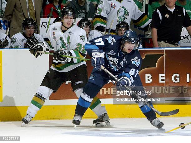 Sidney Crosby of the Rimouski Oceanic plays the puck against Brandon Prust of the London Knights during the Memorial Cup Tournament championship game...