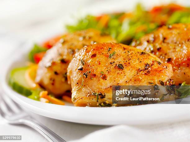 grilled chicken thighs with a side salad - chicken thighs stock pictures, royalty-free photos & images