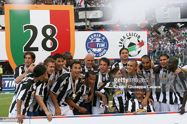 Juventus players celebrate with the trophy for the victory of "scudetto" at the end of the last Serie A football match of the season between Juventus...
