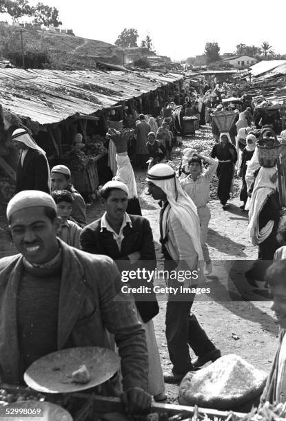 Just over one month after Israel's first occupation of this war-torn area, Arabs shop in the market December 10, 1956 in Gaza City in the Gaza Strip....