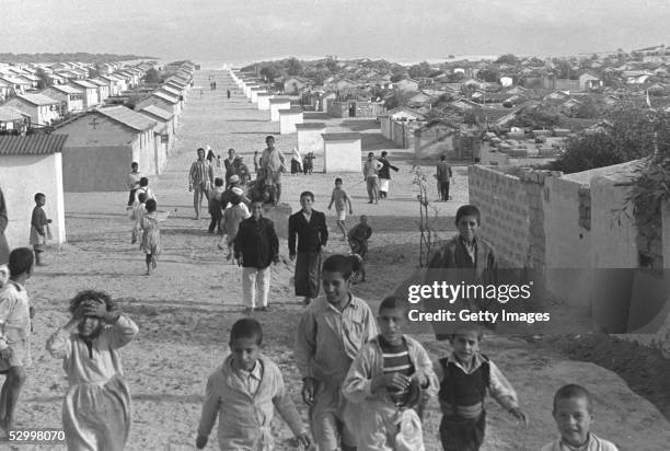 Days after Israel's first occupation of this war-torn area, Arabs walk between their houses in a refugee camp November 1, 1956 in Gaza City in the...