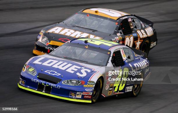 Jimmie Johnson, driver of the Lowe's Chevrolet, leads Joe Nemechek, driver of the U.S. Army Chevrolet, during the NASCAR Nextel Cup Coca-Cola 600 on...