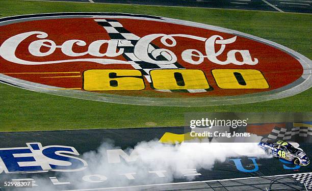 Jimmie Johnson, driver of the Lowe's Chevrolet, burns his tires after winning the NASCAR Nextel Cup Coca-Cola 600 at Lowe's Motor Speedway on May 29,...