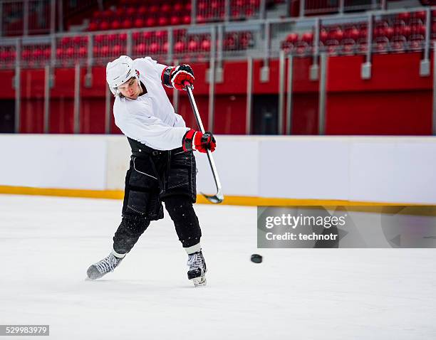 ice hockey player-shooting at goal - ice hockey glove stock-fotos und bilder