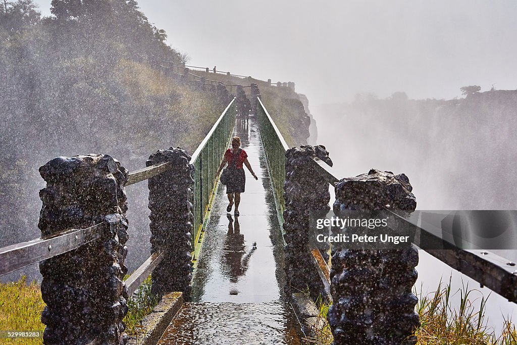 Tourist crosses Knife Edge bridge with mist