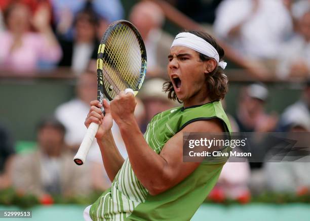 Rafael Nadal of Spain celebrates winning a point against Sebastien Grosjean of France during the fourth round match on the eighth day of the French...