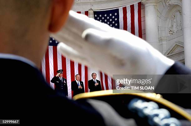 President George W. Bush joined by Secretary of Defense Donald Rumsfeld and Chairman of the Joint Chiefs, General Richard Myers salute during the...