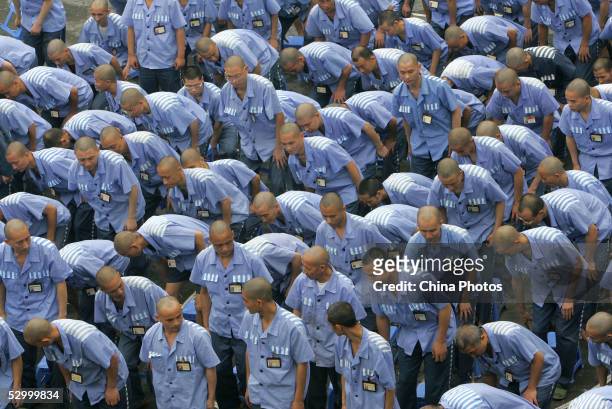 Inmates take their seat during a behavior training session at Chongqing Prison on May 30, 2005 in Chongqing Municipality, China. According to state...