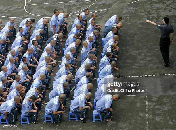 Inmates listen to a police officer during a behavior training session at Chongqing Prison on May 30, 2005 in Chongqing Municipality, China. According...