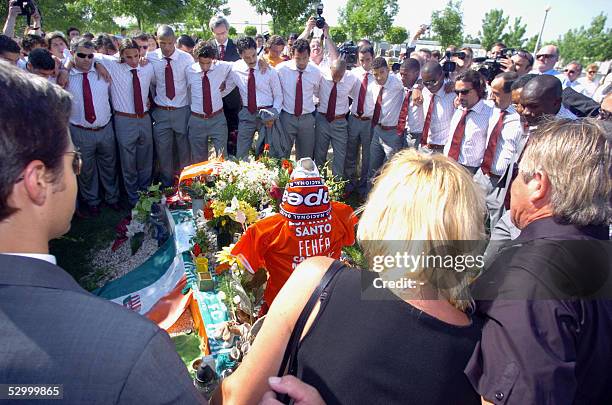Leaders and players of champion football team Portuguese Benfica pray with the perents in front of their late teammate Miklos Feher's grave in the...
