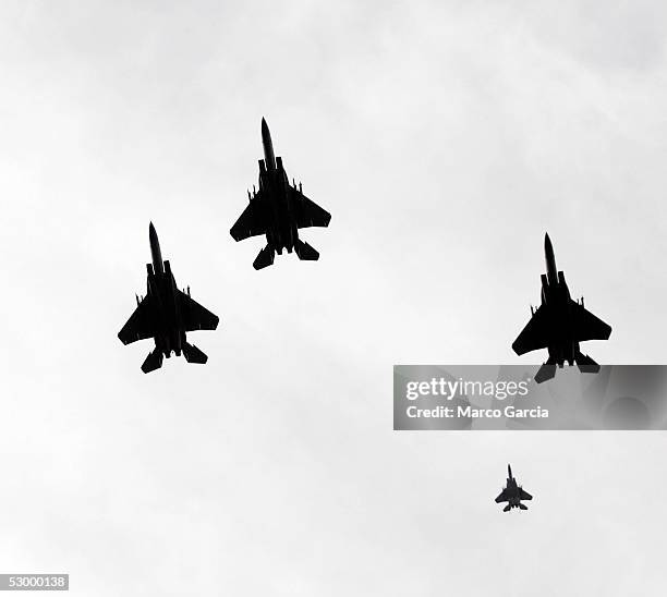 Military jets fly in a ceremonial "missing man" formation over the National Memorial Cemetery of the Pacific May 30, 2005 in Honolulu, Hawaii.