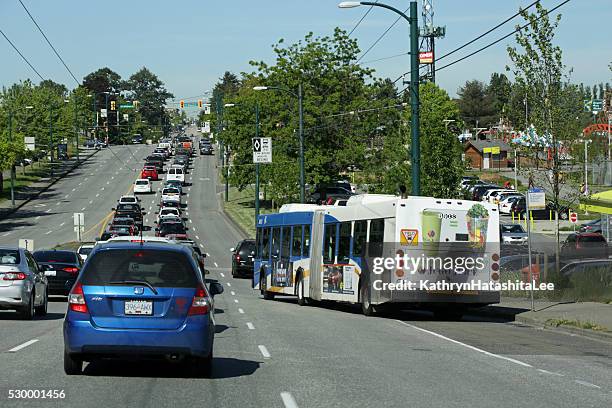 traffic on east hastings street, vancouver, canada in spring - east vancouver stock pictures, royalty-free photos & images