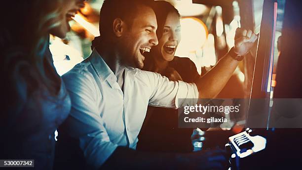 group of people having fun in casino. - kasino stock pictures, royalty-free photos & images