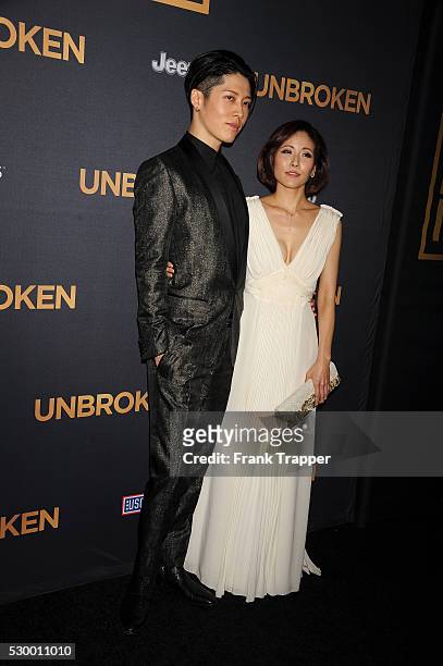 Actor and composer Takamasa Ishihara and actress/wife Melody Miyuki Ishikawa arrive at the premiere of "Unbroken" held at The Dolby Theater in...