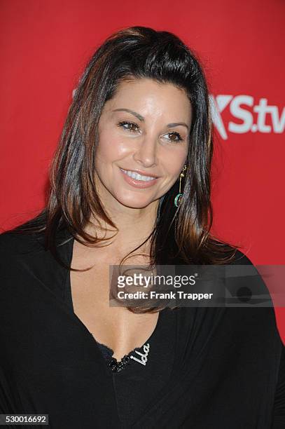 Actress Gina Gershon arrives at the 2013 MusiCares Person Of The Year Gala Honoring Bruce Springsteen held at the Los Angeles Convention Center.