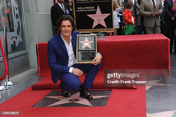 Actor Orlando Bloom posing at the ceremony that honored him with a Star on the Hollywood Walk of Fame.