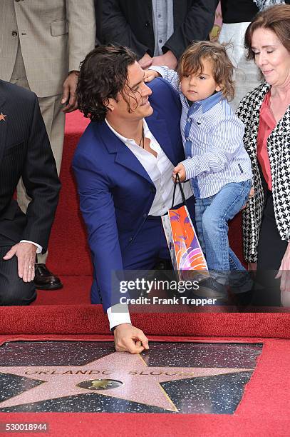 Actor Orlando Bloom and son Flynn pose at the ceremony that honored him with a Star on the Hollywood Walk of Fame.