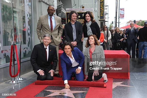 Actor Orlando Bloom pose with guests at the ceremony that honored him with a Star on the Hollywood Walk of Fame.