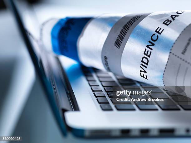 close up of laptop computer ready to take away in forensic evidence bag - future proof stock pictures, royalty-free photos & images