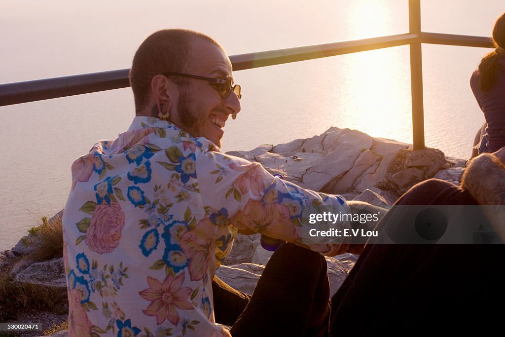 Two young men sitting chatting at coast, Marseille, France