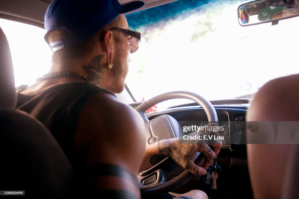 Close up of young man driving on car road trip